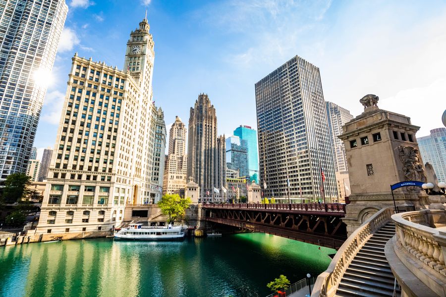 Chicago River with the white Wrigley Building, a bascule bridge and downtown towers on a sunny day